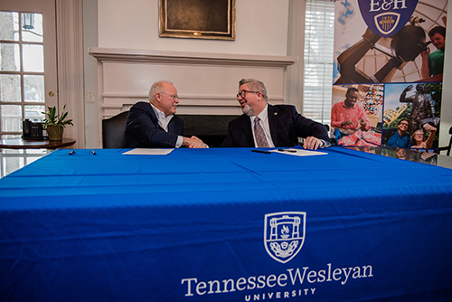 President of Tennessee Wesleyan University, Harley Knowles (left) and Emory & Henry President, John Wells (right) shake hands after signing the official agreement.