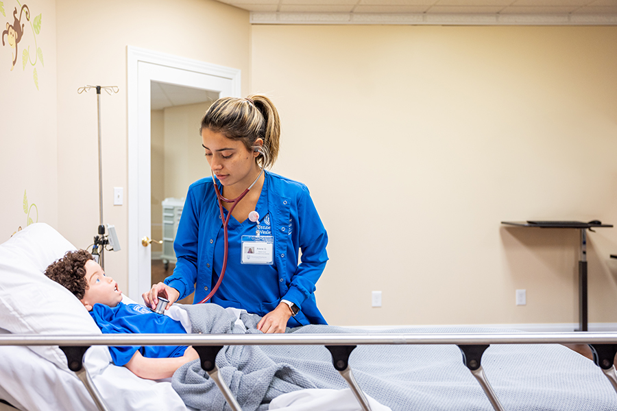 Nursing student tending to a patient