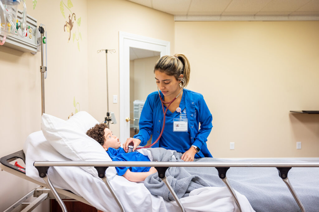 Nursing student practicing on a dummy