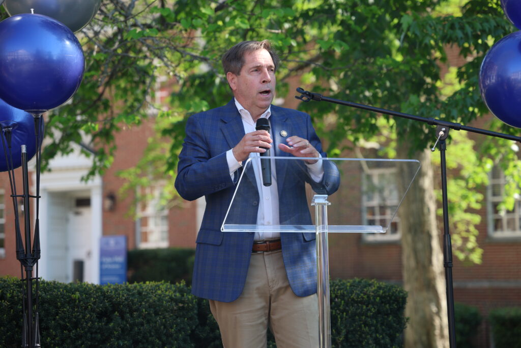 Congressman Fleischmann stands at a podium to address the crowd