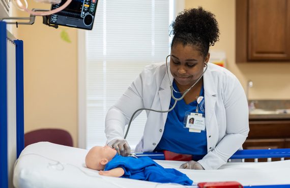 Nursing student practicing on a dummy